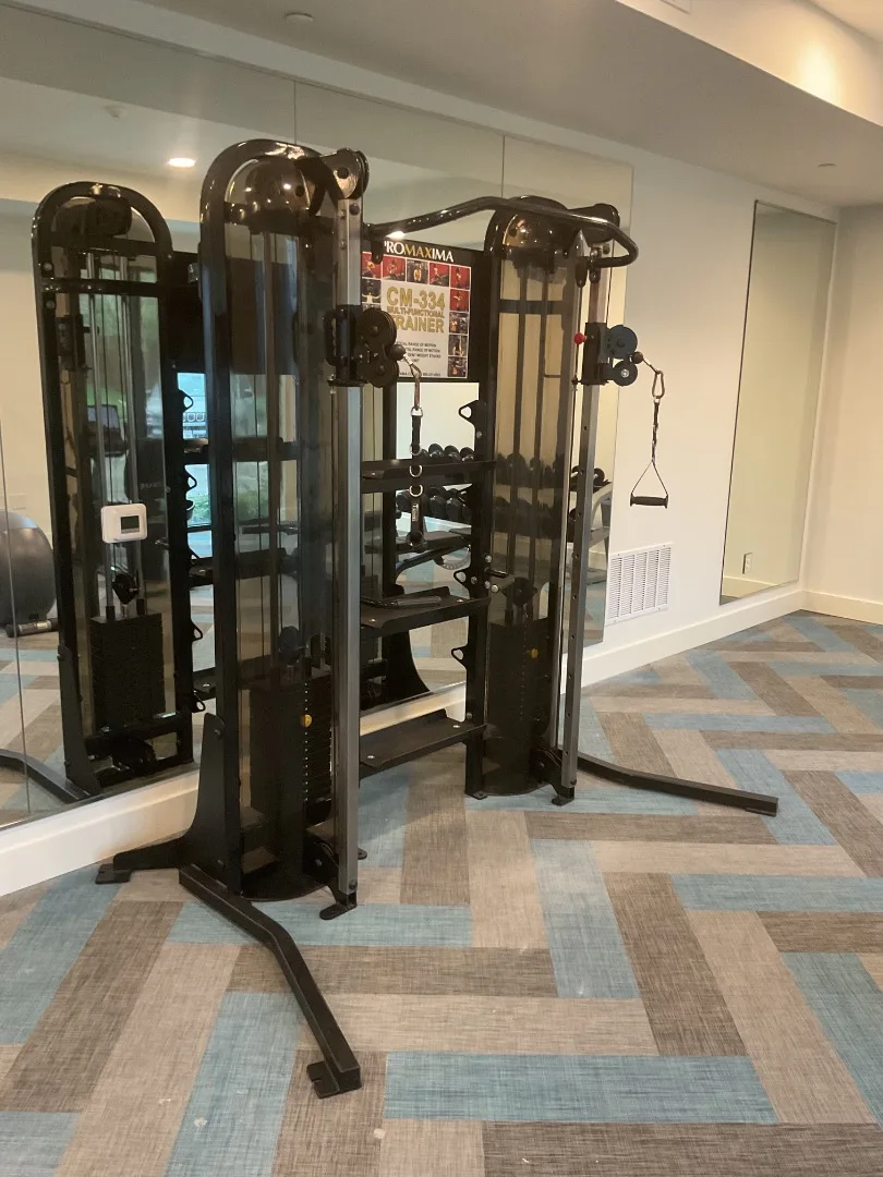Functional trainer against a mirrored wall in a Plano apartment gym