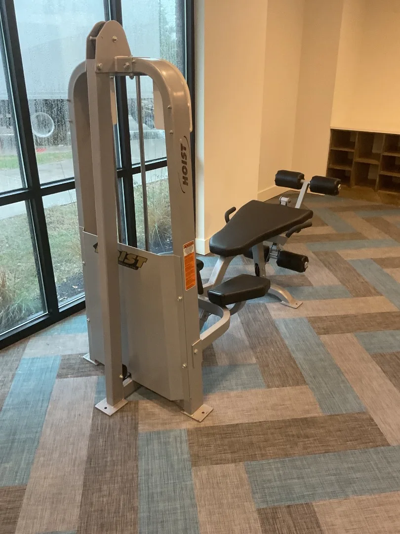 Hoist leg-extension and leg-curl combo machine by the window wall