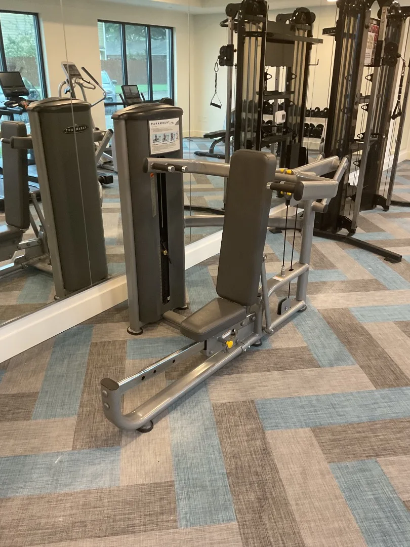 Paramount selectorized overhead press station beside the functional trainer