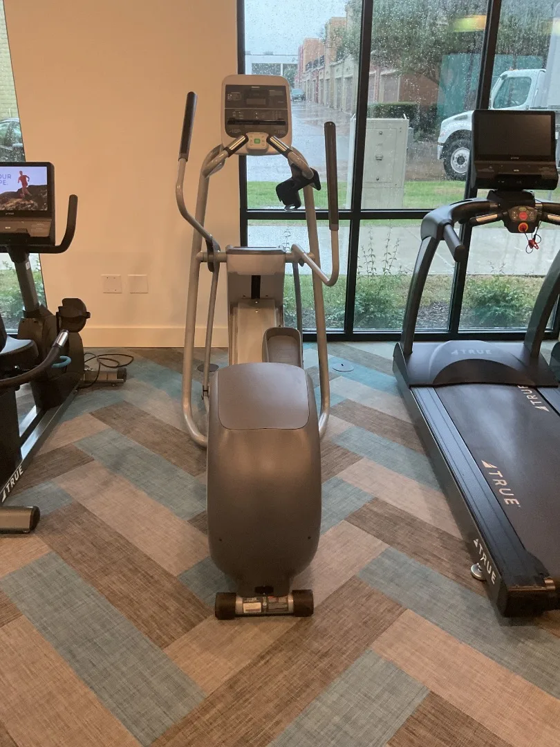 Precor lower-body elliptical between the recumbent bike and treadmills in the cardio row