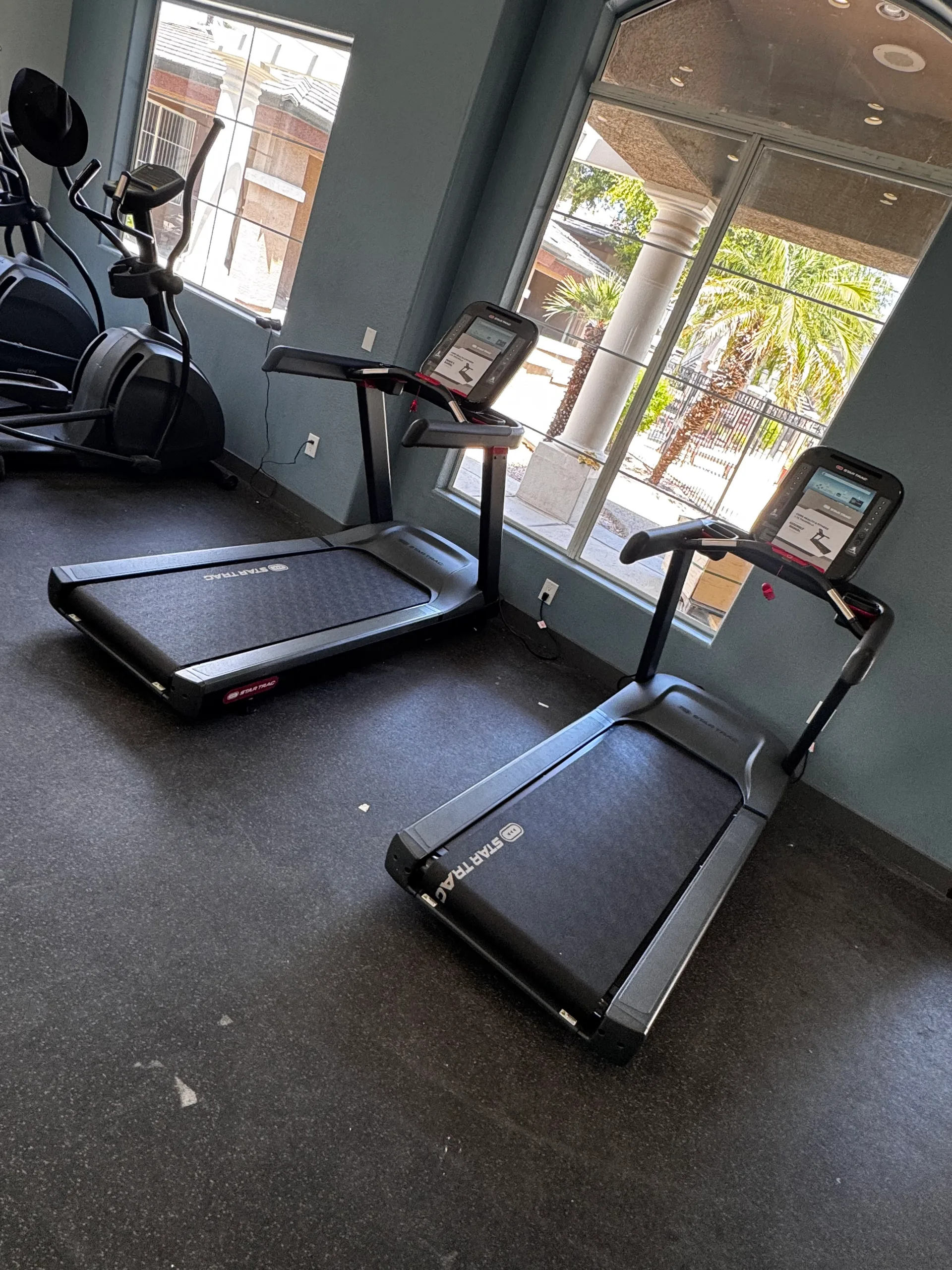 Treadmill row set against full-height windows