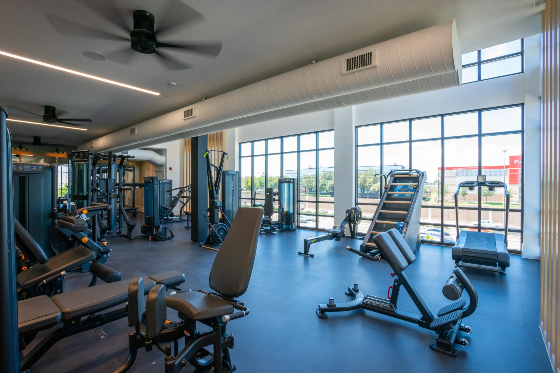 Matrix rower beside a cardio row in an amenity gym
