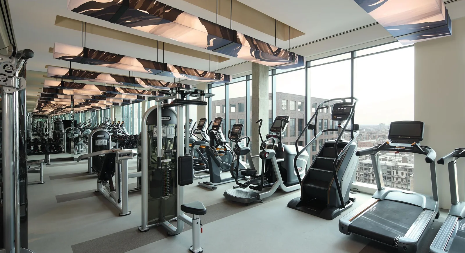 Commercial club cardio floor behind a glass wall